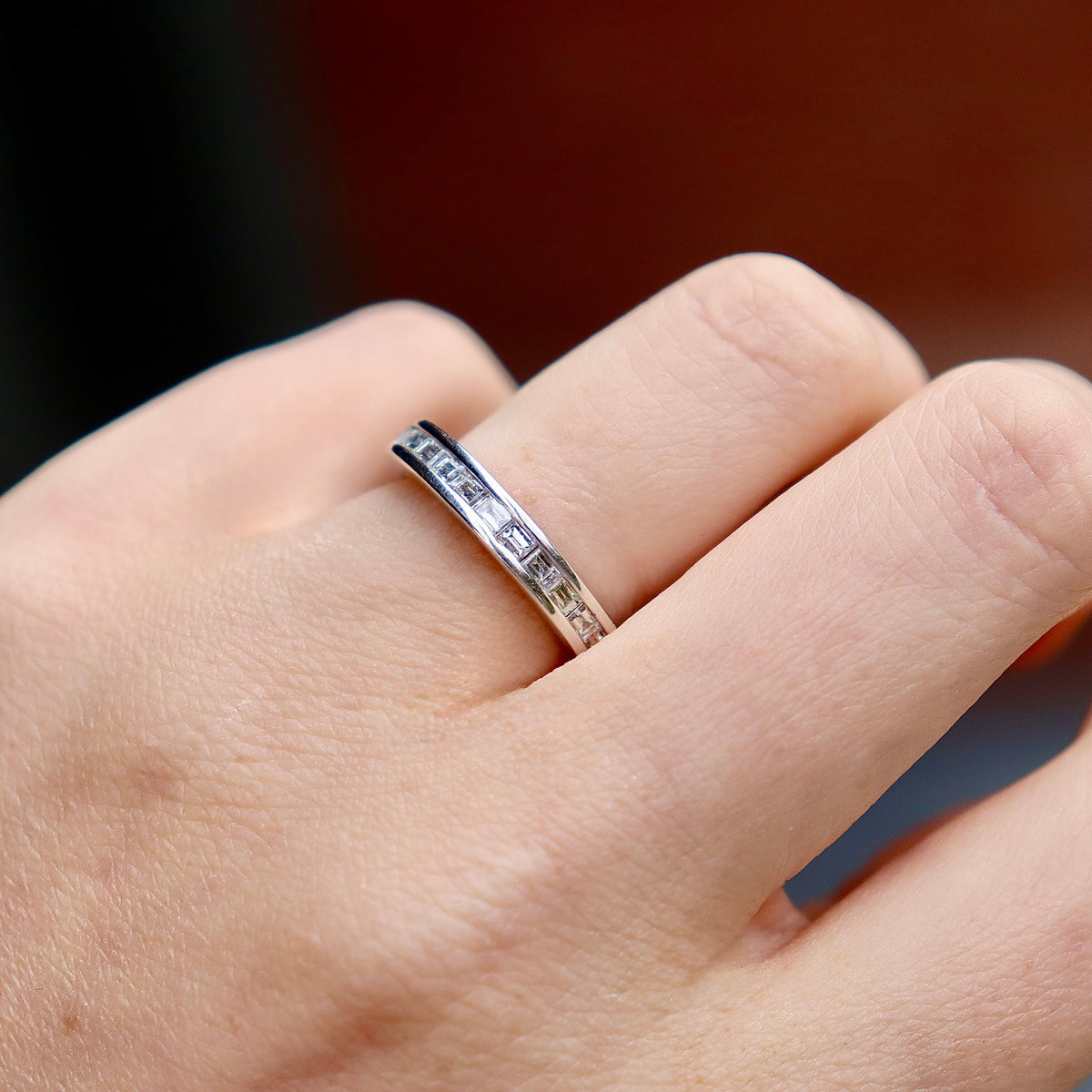 Close-up of 18ct white gold baguette diamond wedding band highlighting the clean geometric diamond details