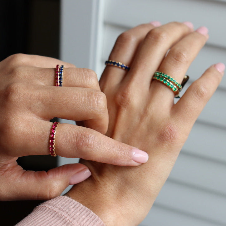 Yellow gold ruby wedding ring featuring one carat total ruby weight