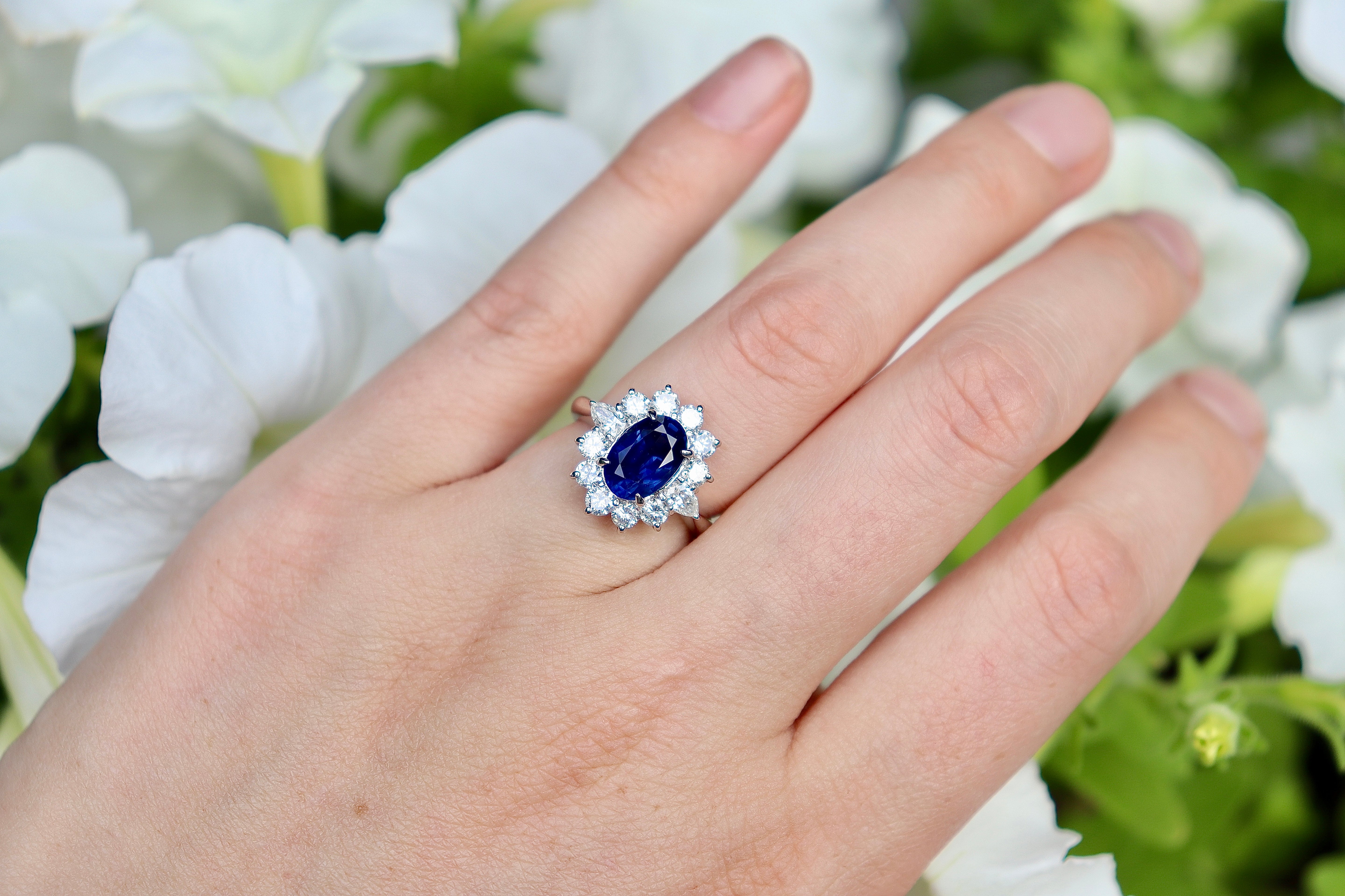Luxury sapphire engagement ring with pear-shaped diamond halo