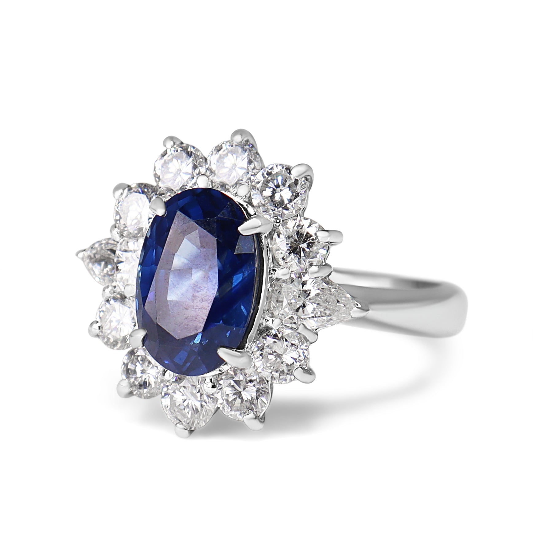 Close-up of platinum sapphire and diamond cluster ring detailing