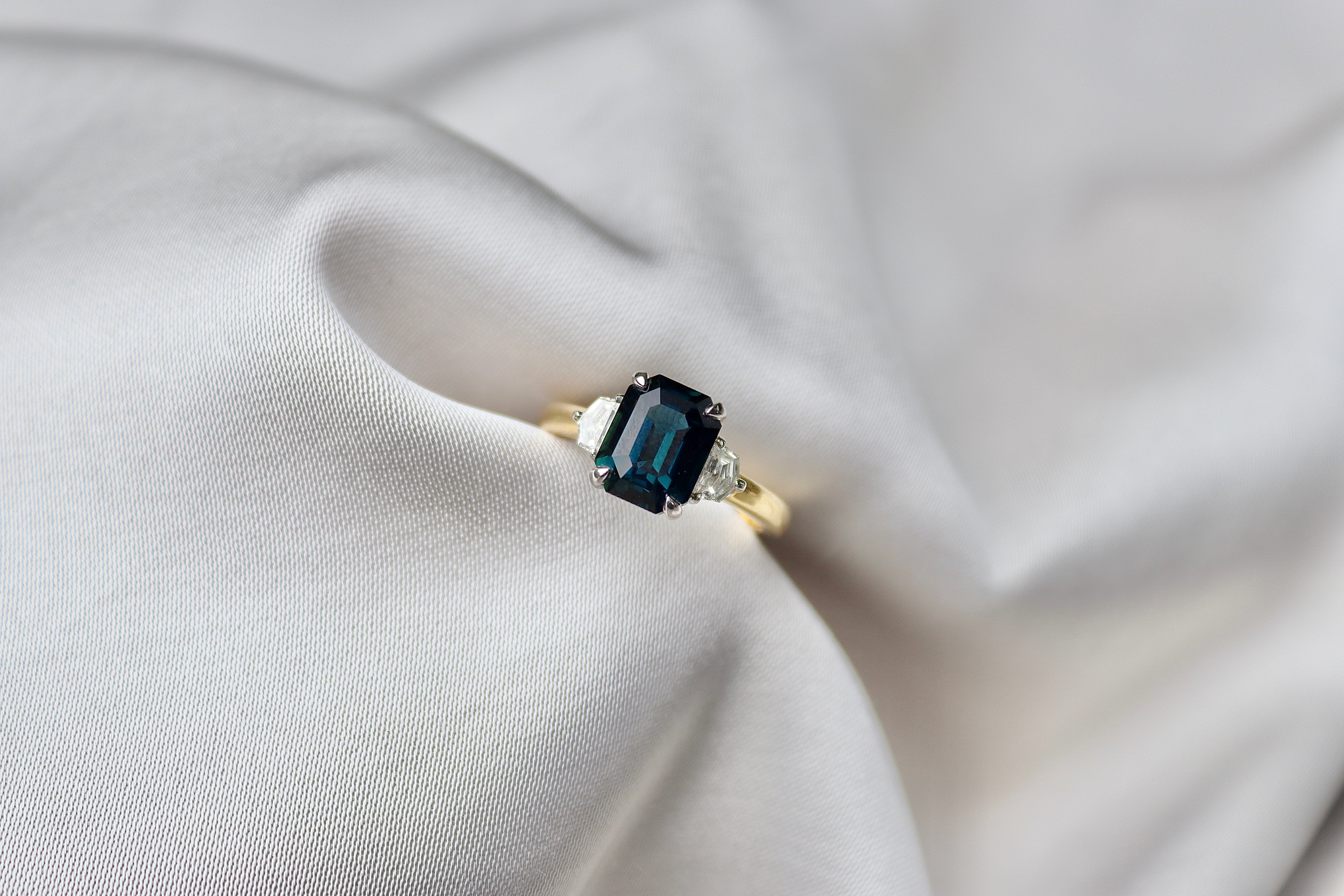 18ct Yellow and White Gold Emerald Cut Teal Sapphire and Cadillac Diamond 3 Stone Ring