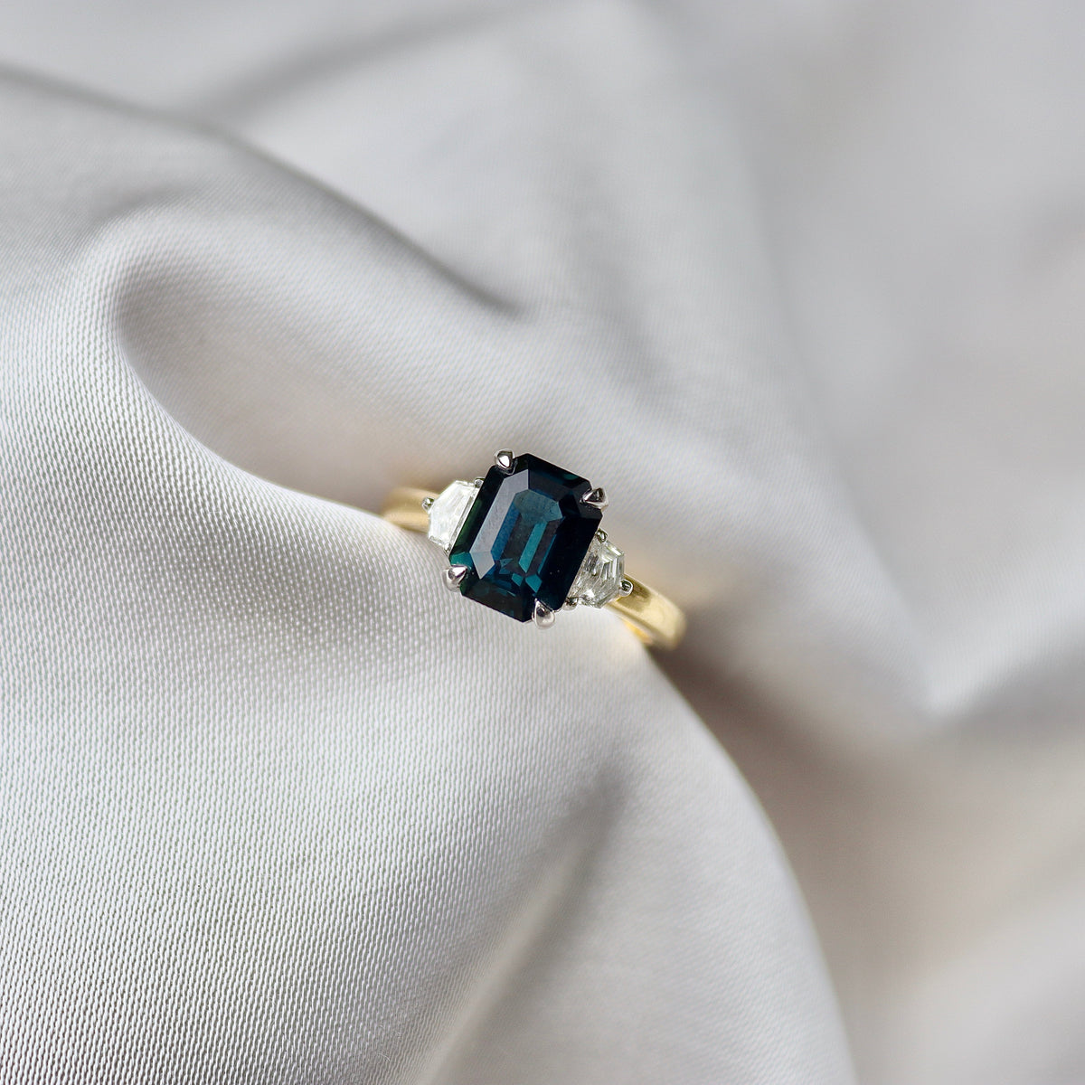 18ct Yellow and White Gold Emerald Cut Teal Sapphire and Cadillac Diamond 3 Stone Ring
