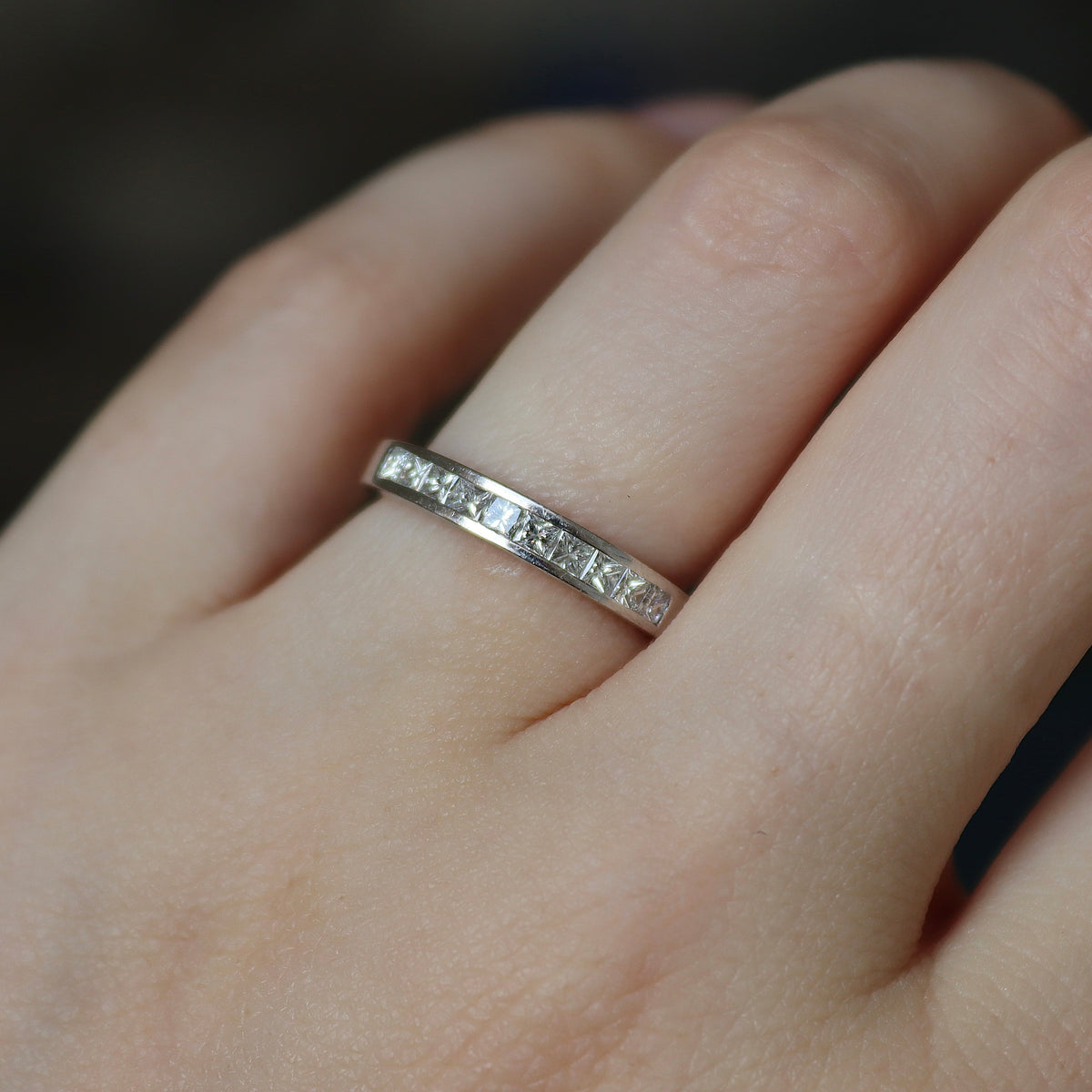 Close-up of a princess cut channel set diamond wedding ring