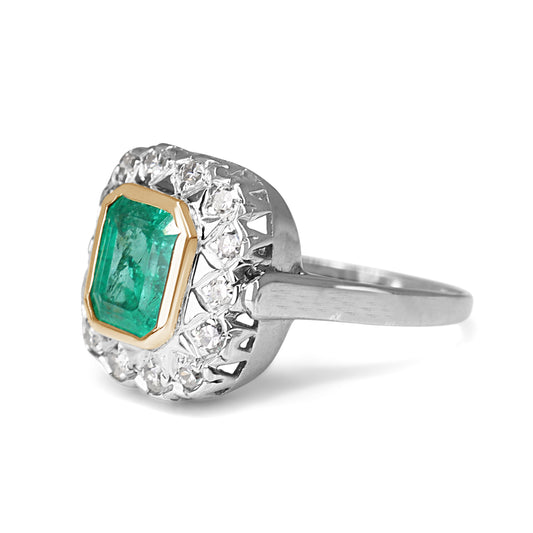 Luxury emerald and diamond engagement ring on white background