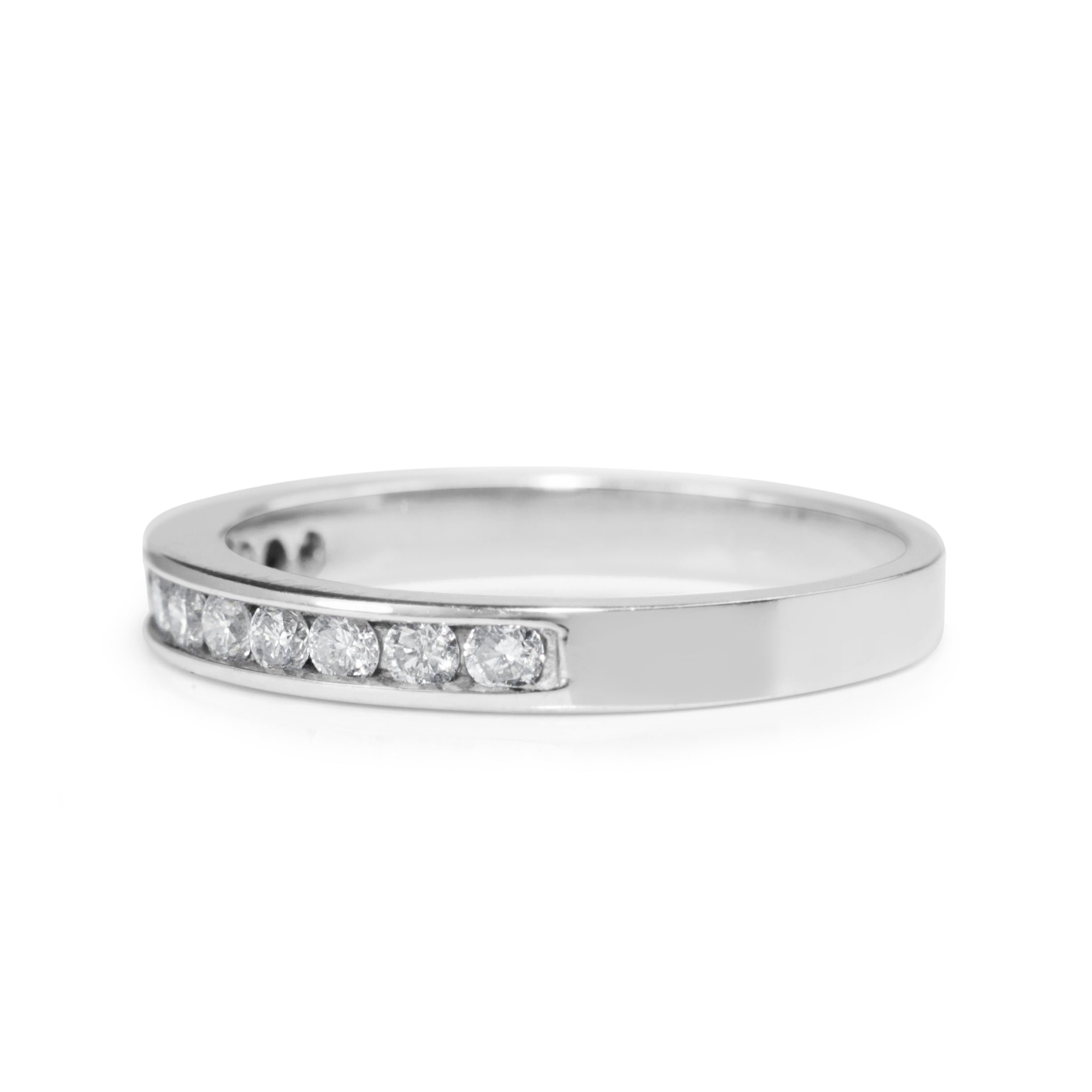 Angled view of 14ct white gold channel set diamond band showing the diamond setting