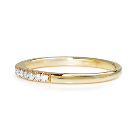 Angled view of 18ct yellow gold 1.9mm diamond band showing the diamond-set front and polished side
