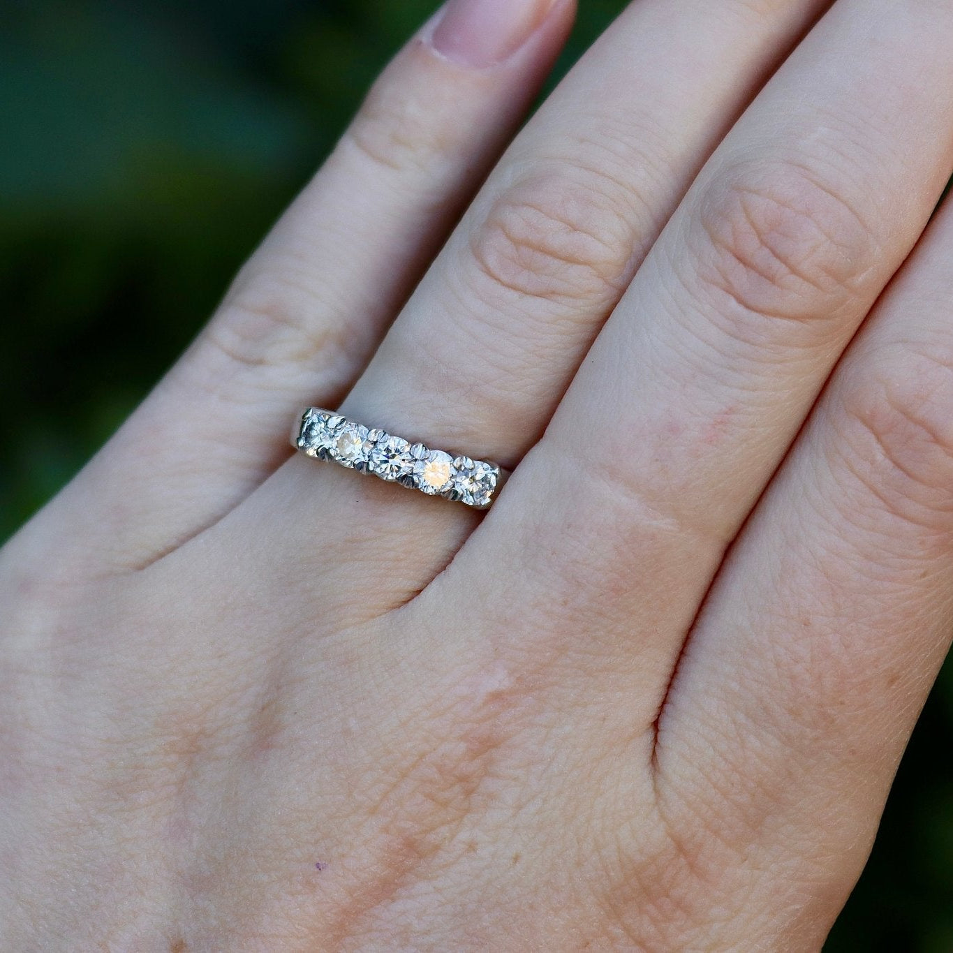 Close view of an 18ct white gold five stone diamond ring showing five diamonds across the 4.1 mm top