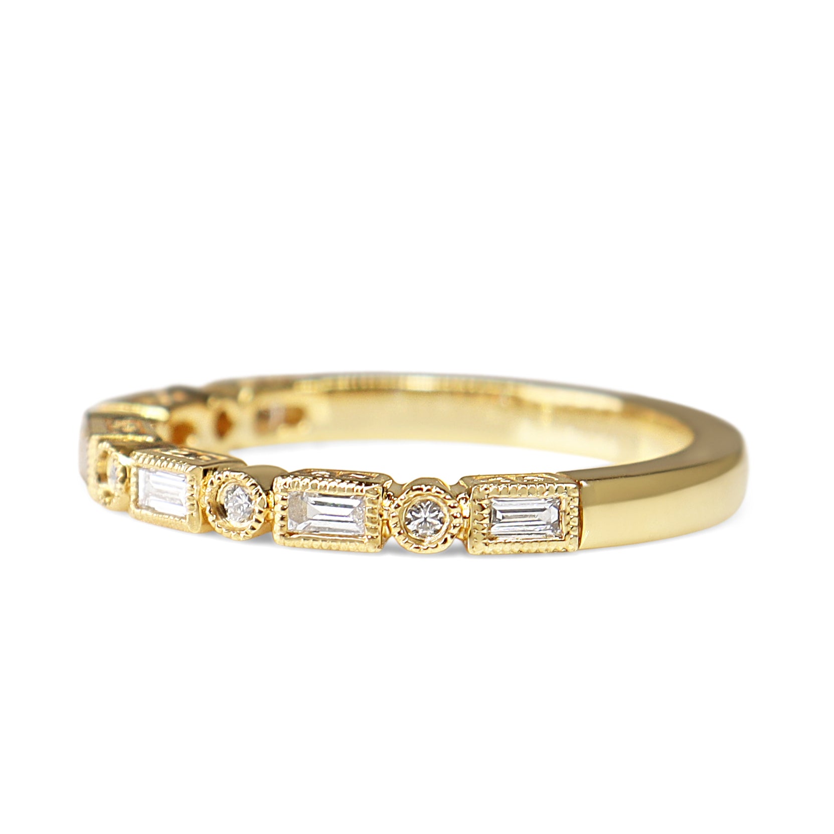 Angled view of 18ct yellow gold Deco style diamond band showing the alternating diamond details