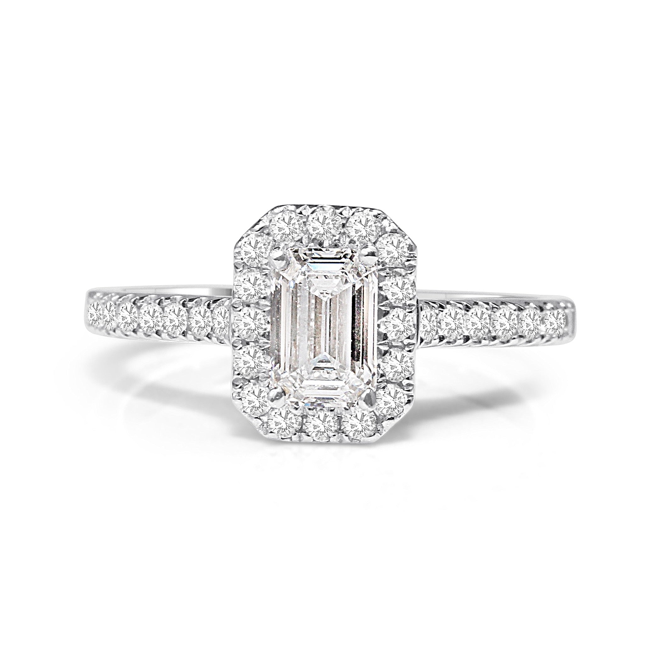 An 18ct white gold emerald cut halo ring with a central diamond and smaller surrounding diamonds set in a white gold band.
