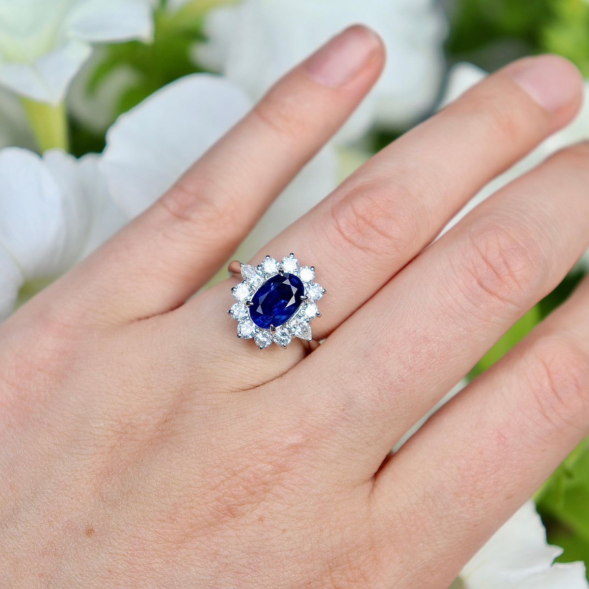 Luxury sapphire engagement ring with pear-shaped diamond halo