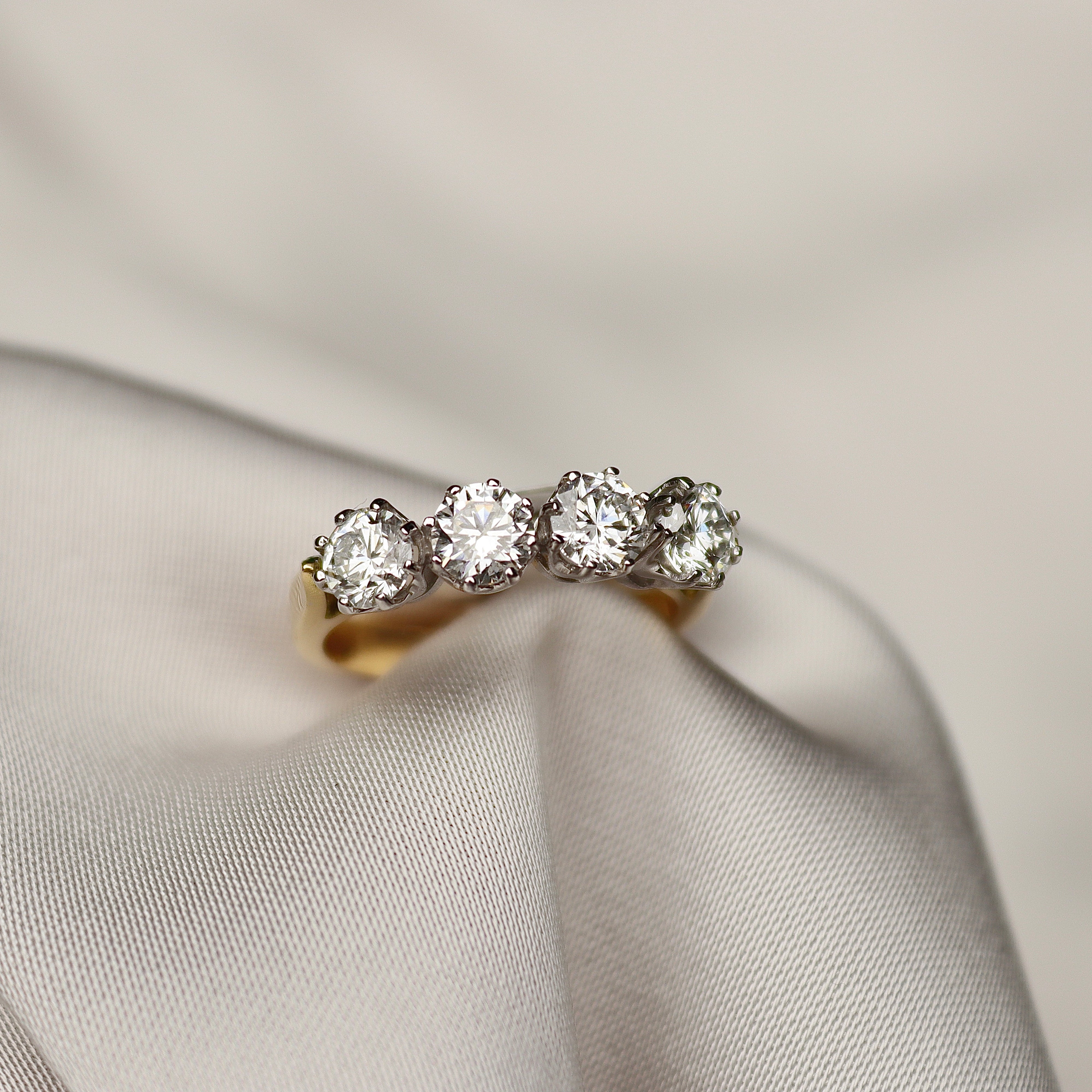 18ct yellow and white gold antique-style diamond ring showing its 5.6 mm top and four-stone design