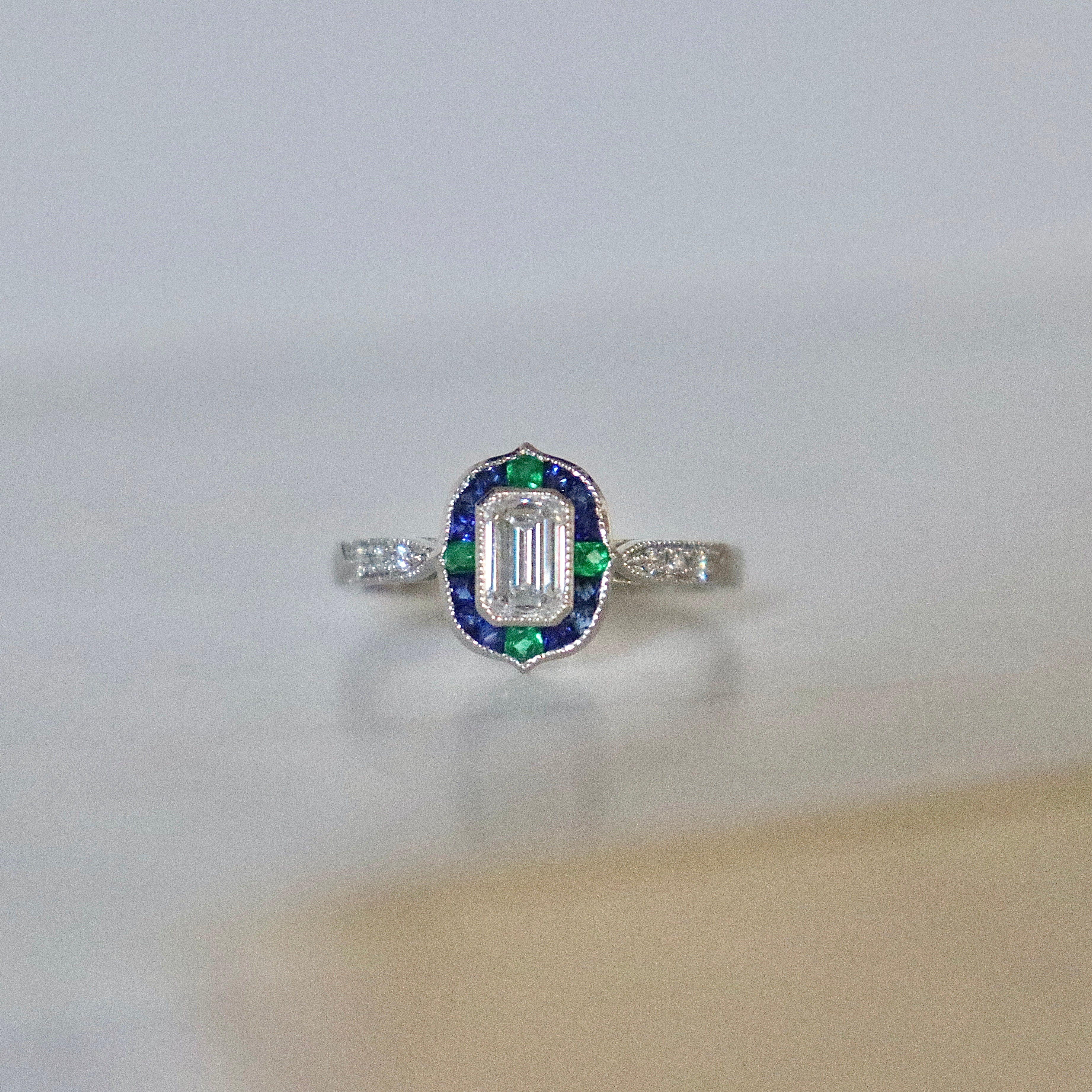 Platinum Emerald Cut Diamond with Sapphire and Emerald Art Deco Style Halo