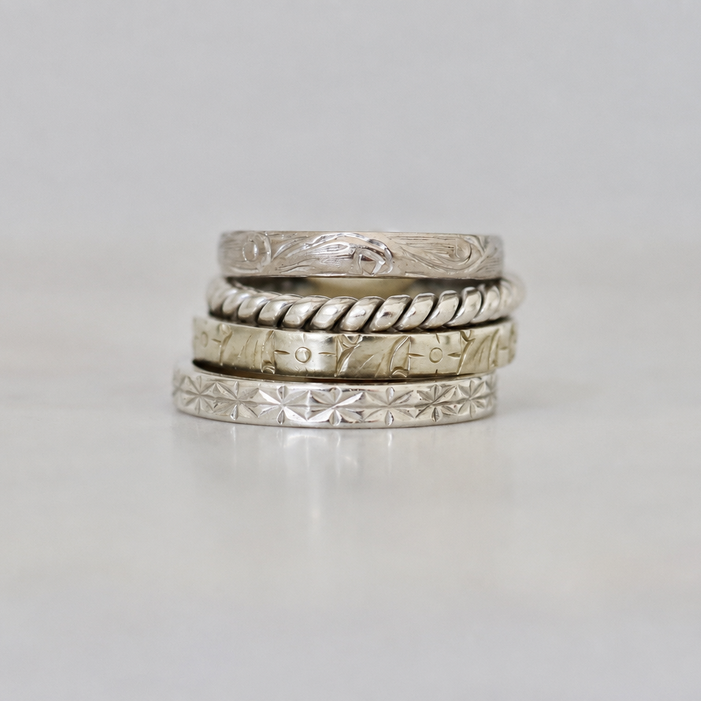Platinum twist band ring photographed flat to show its continuous intertwined design and elegant narrow profile