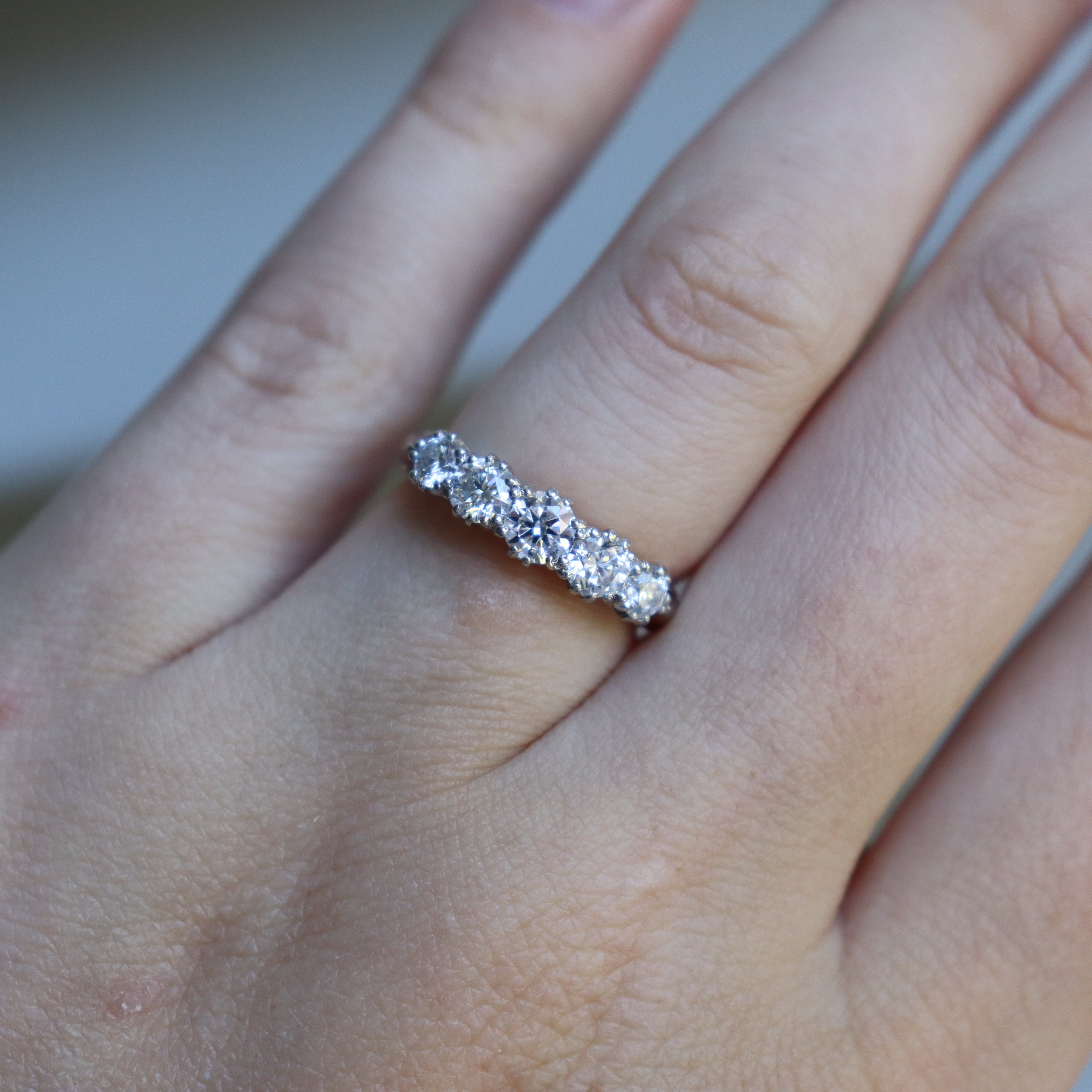 Close-up of 18ct white gold five stone diamond ring highlighting the antique-style diamond detailing