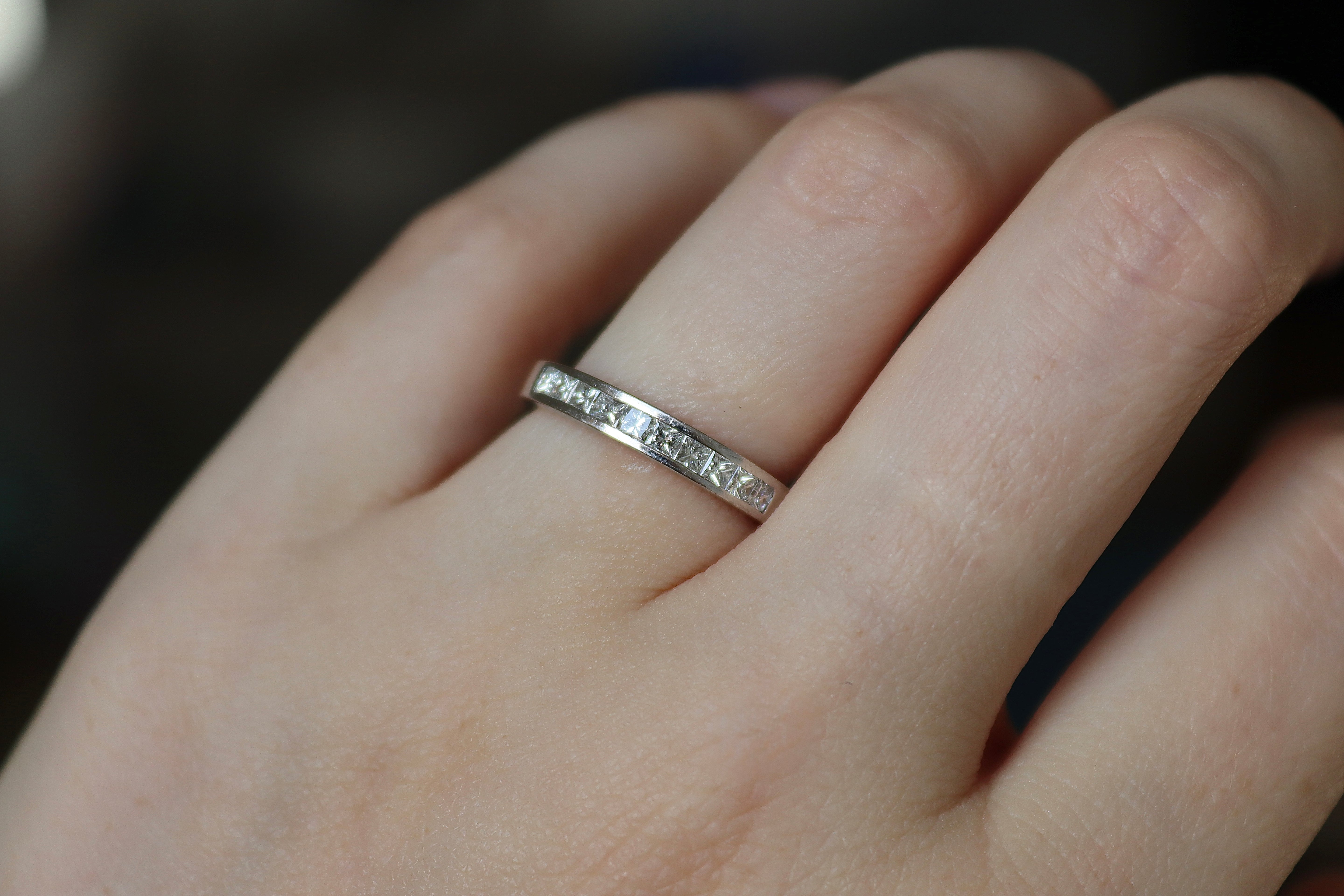 Close-up of a princess cut channel set diamond wedding ring