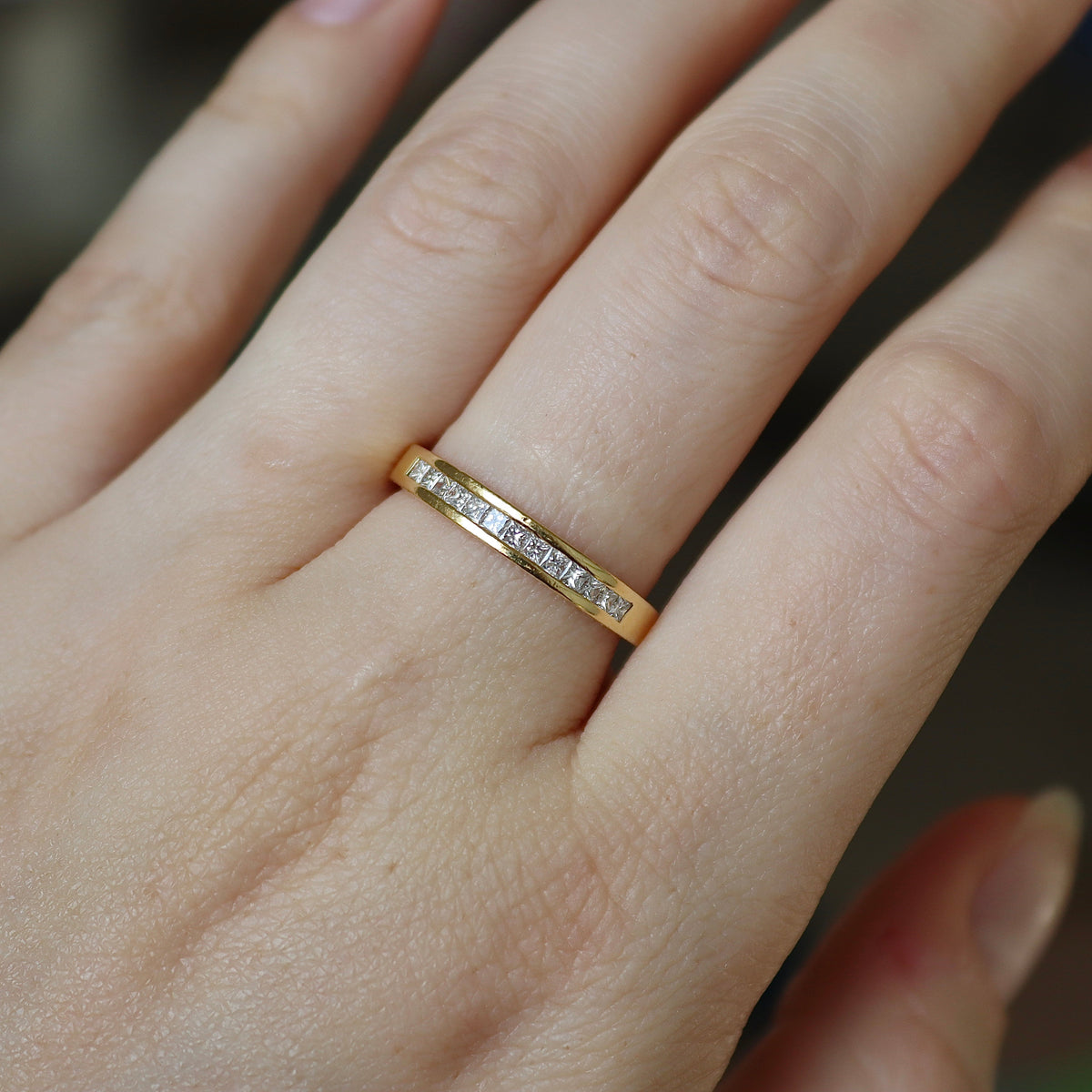 Polished 18ct yellow gold ring showcasing 0.50ct princess cut natural diamonds