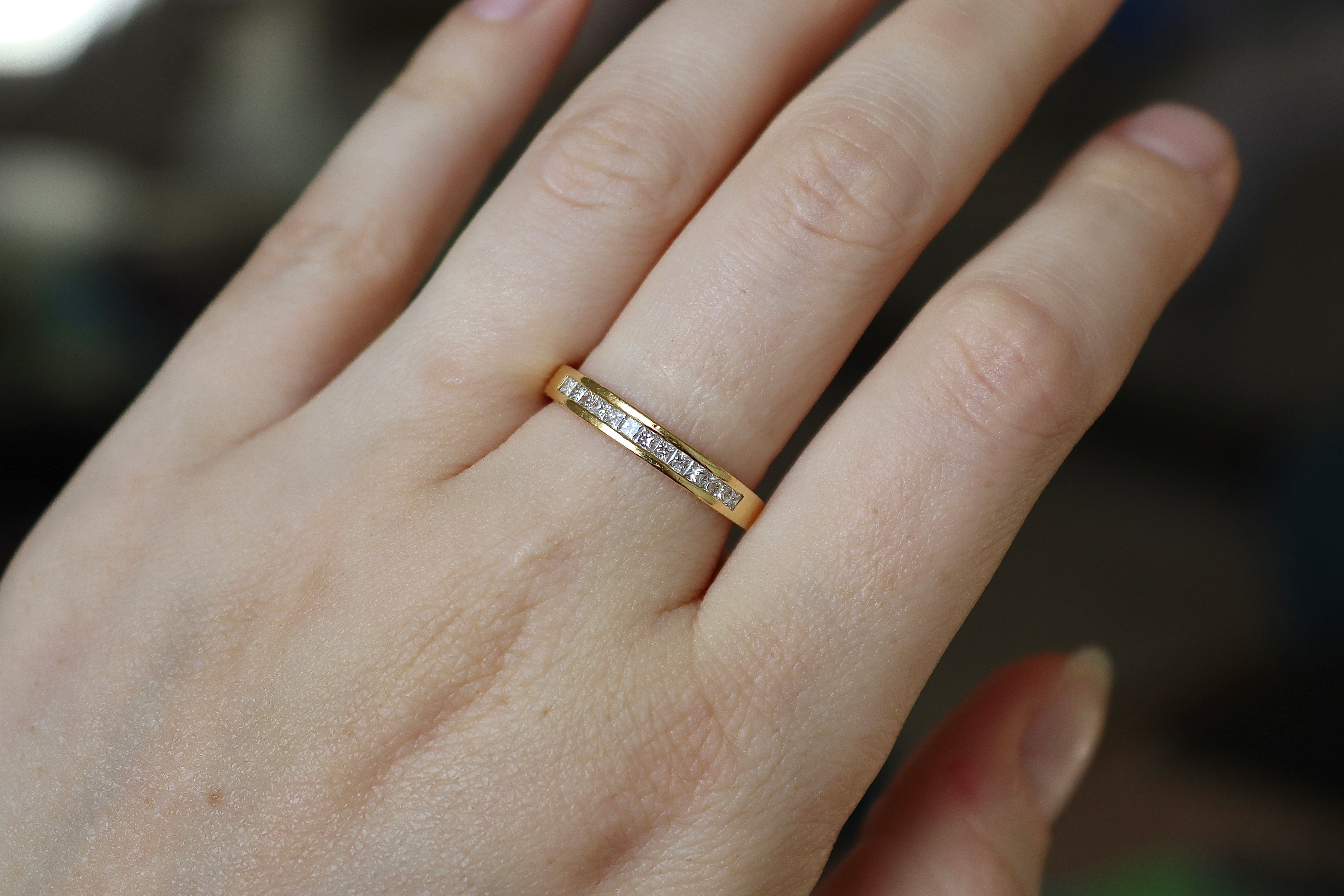 Polished 18ct yellow gold ring showcasing 0.50ct princess cut natural diamonds