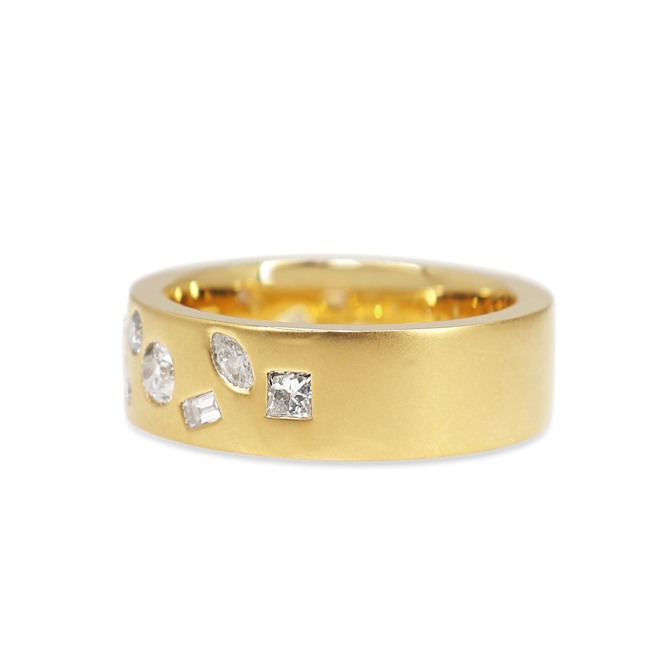 Close-up of mixed shape diamonds set in matte yellow gold band