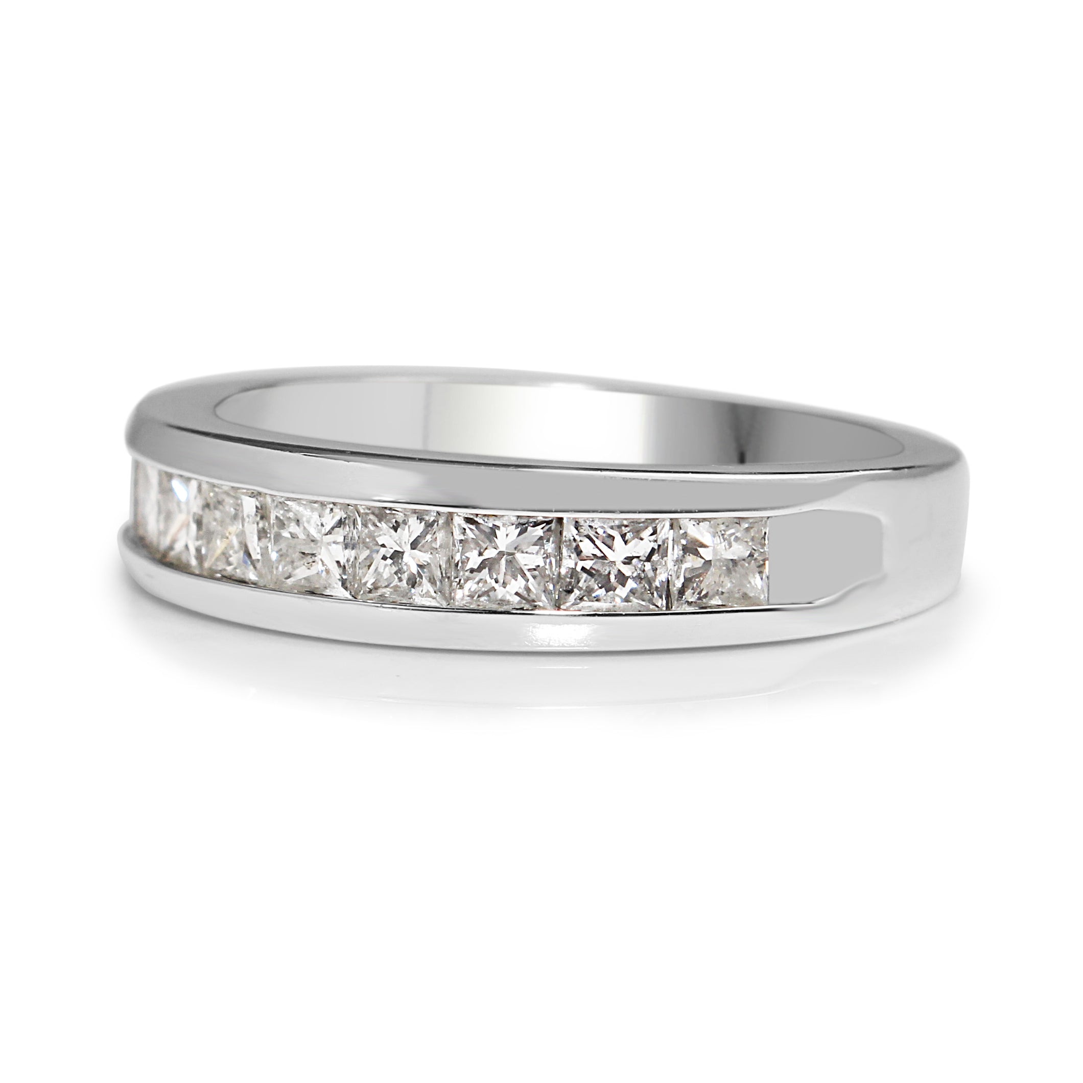 Angled view of 14ct white gold princess cut diamond band showing the diamond-set front and polished band