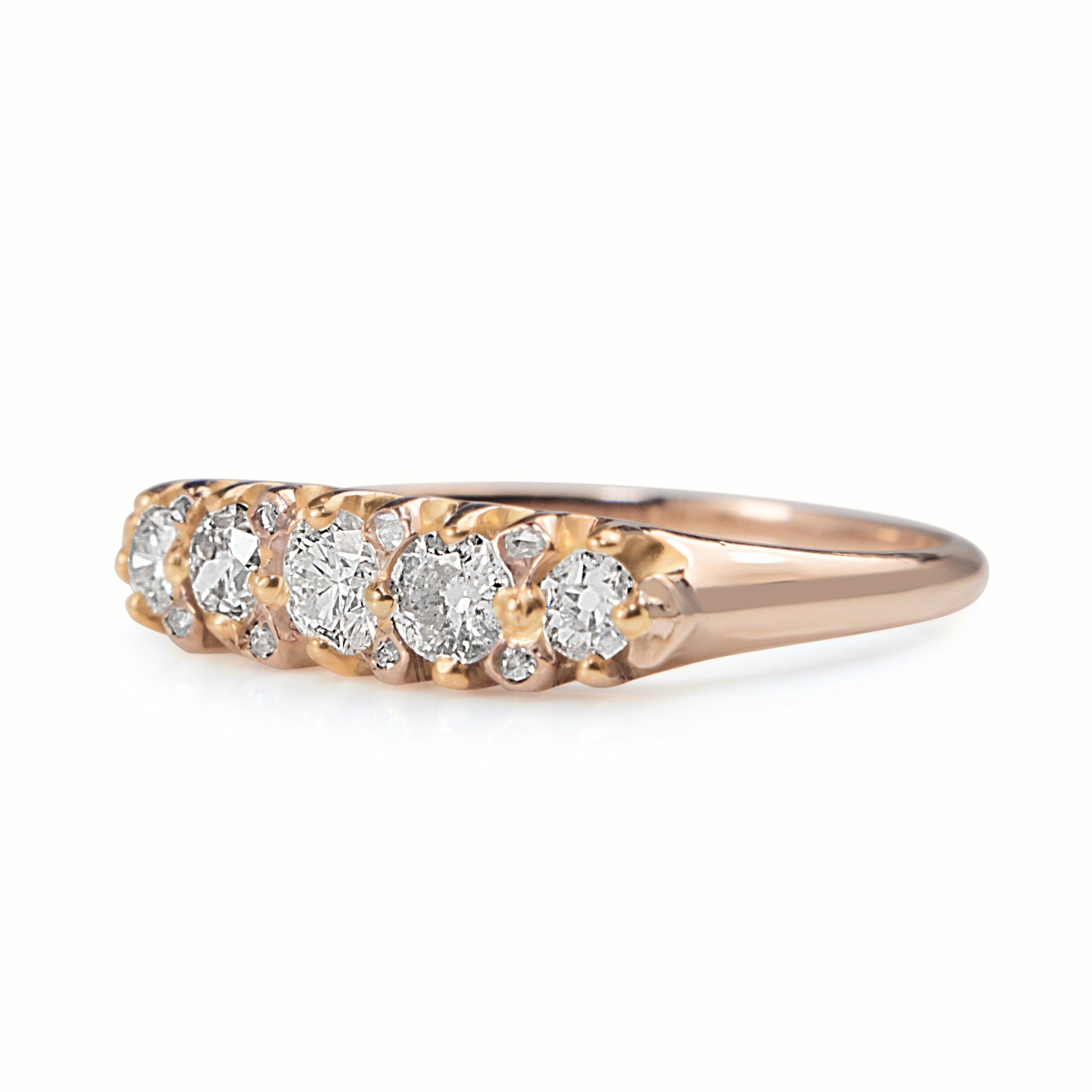 Side view of 18ct rose gold old cut diamond five stone ring