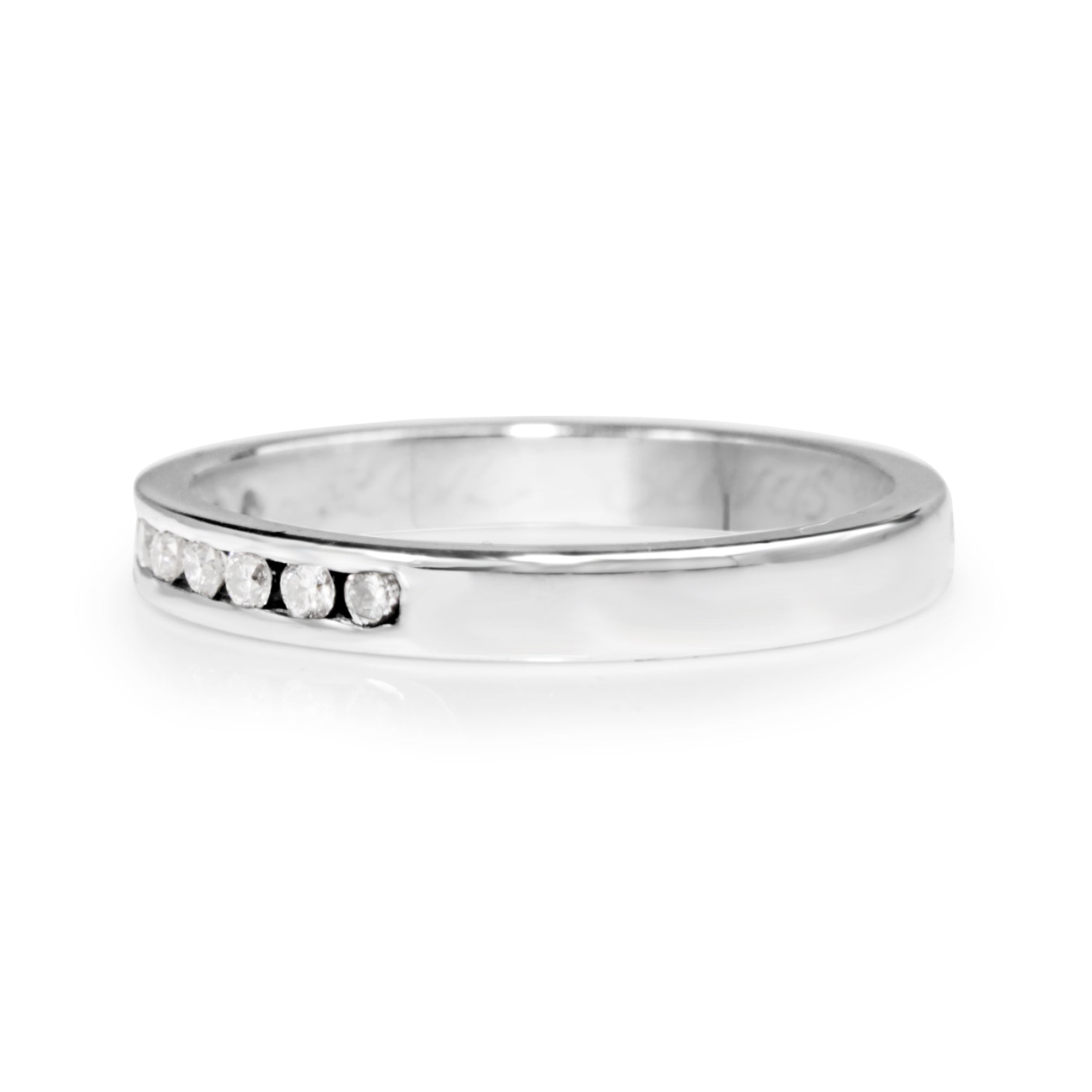 Angled view of 18ct white gold channel set diamond band showing the diamond-set front and plain band