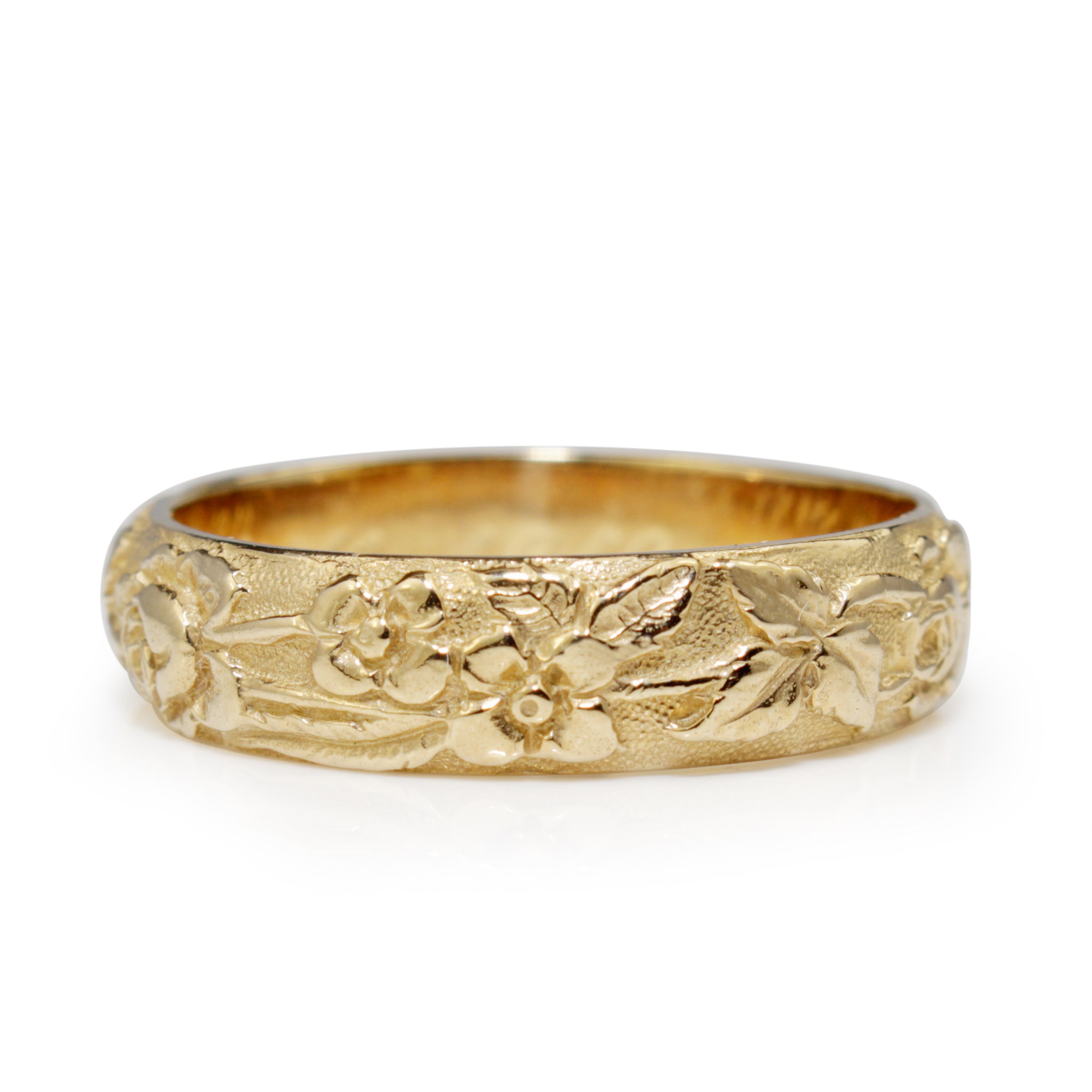 Front view of 9ct yellow gold engraved floral band showing detailed flower and leaf motifs