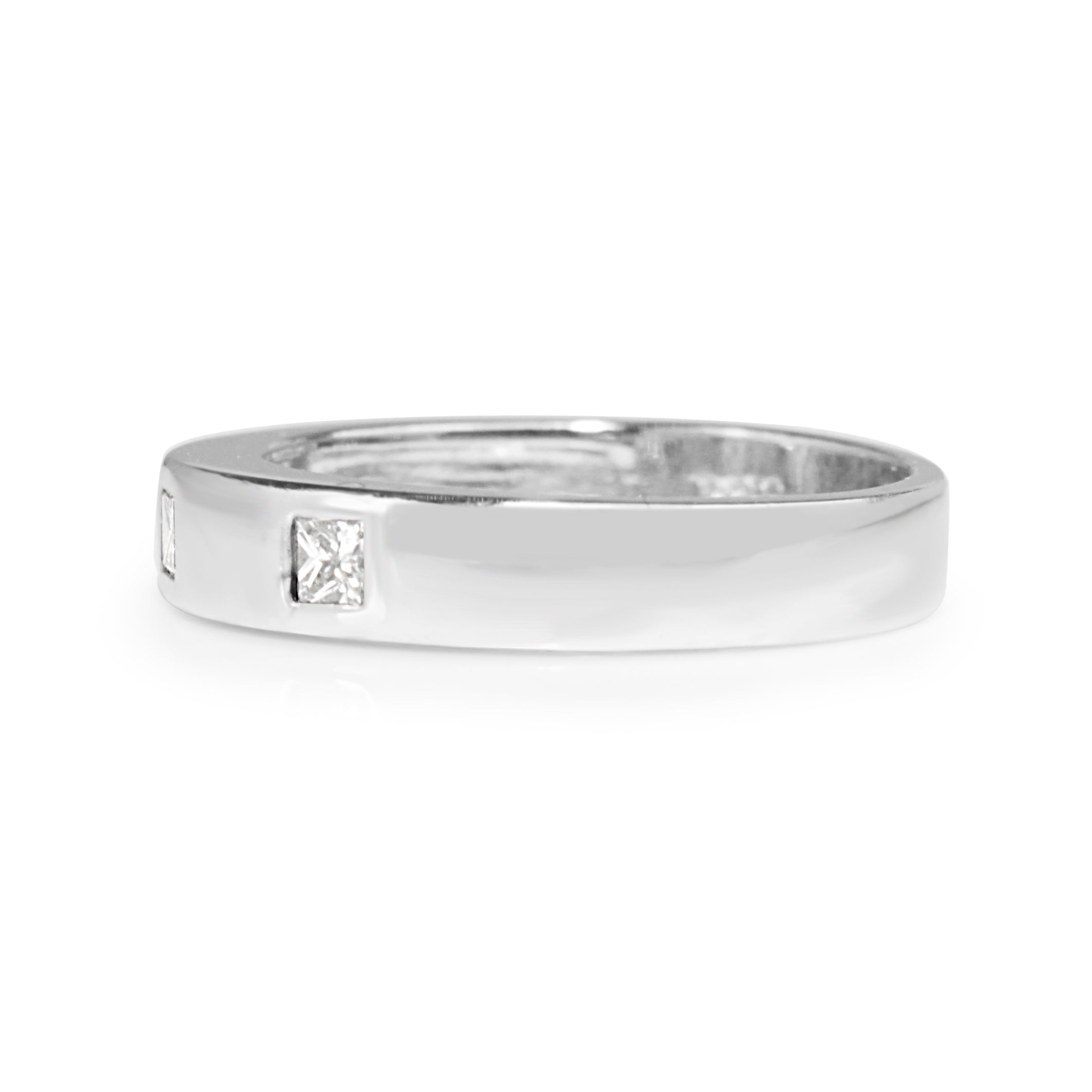 Angled view of platinum princess cut diamond band showing the diamond-set front and plain band