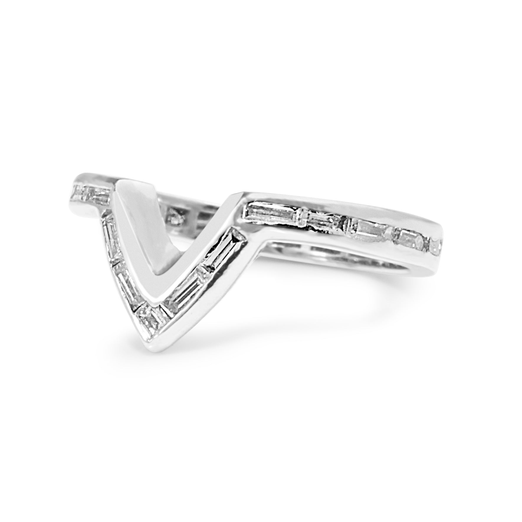 Angled view of platinum V shape baguette diamond band showing the contoured diamond design