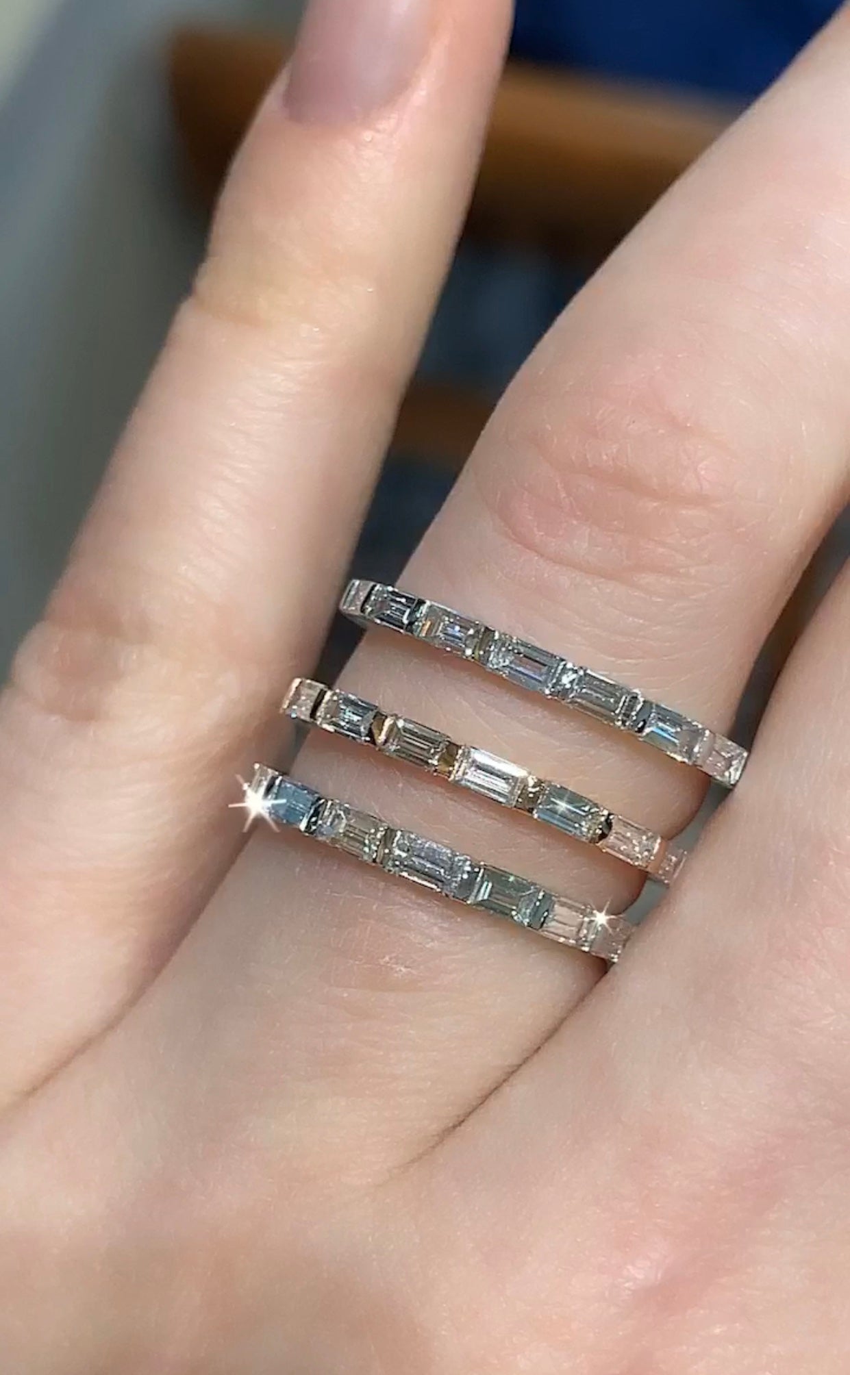 Baguette diamond bands shown on hand for size and design comparison
